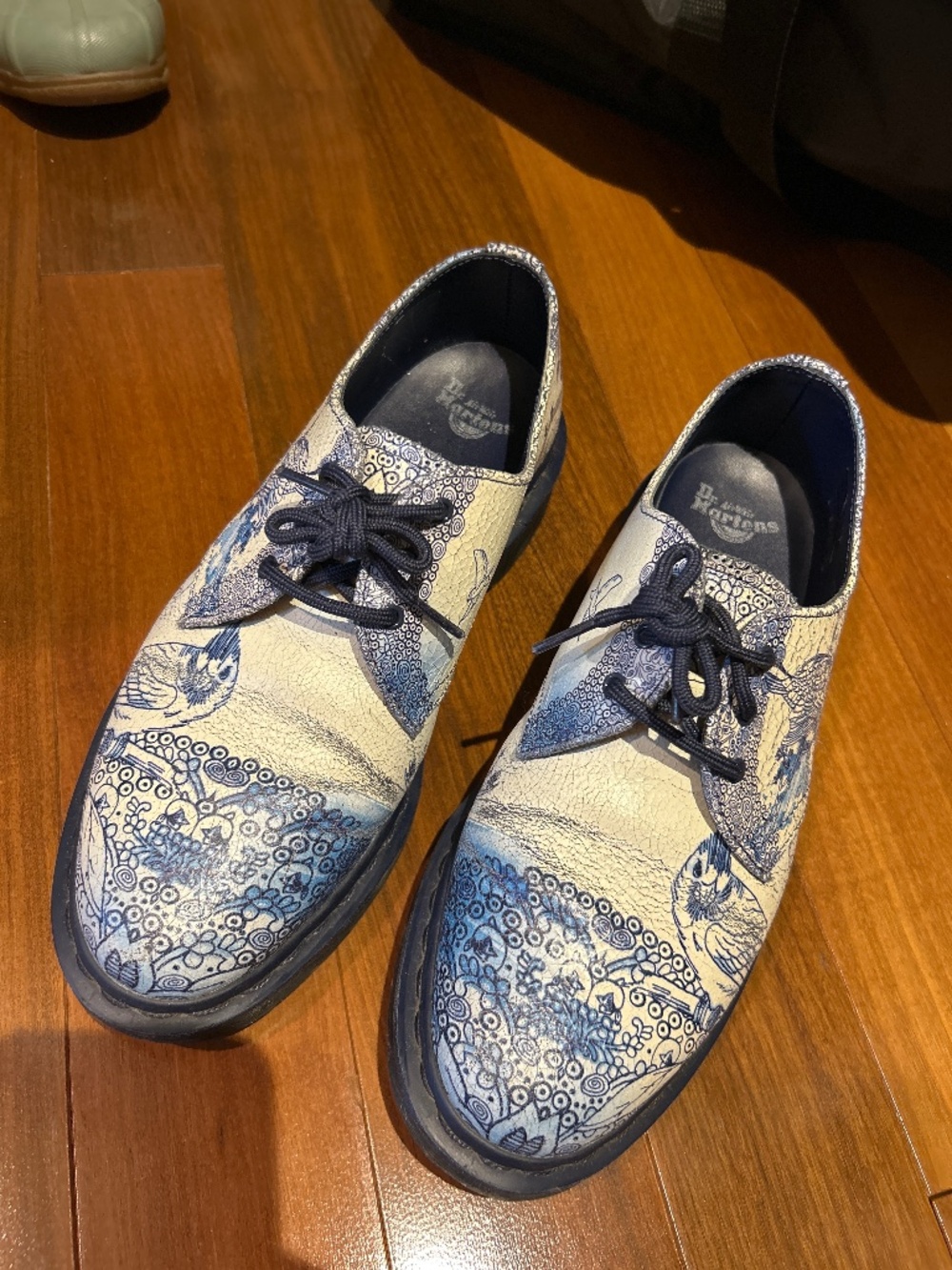 Blue and white Doc Martens with bird design